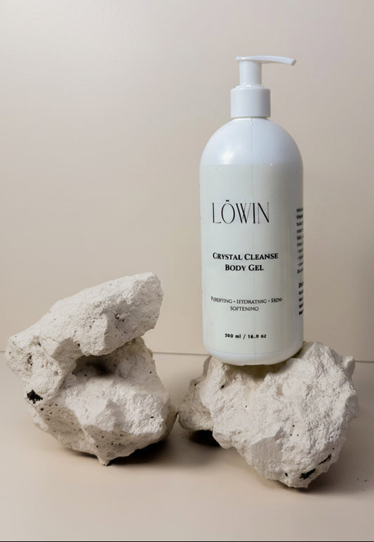 Löwin Crystal Cleanse Body Gel bottle on a neutral background with rocks.