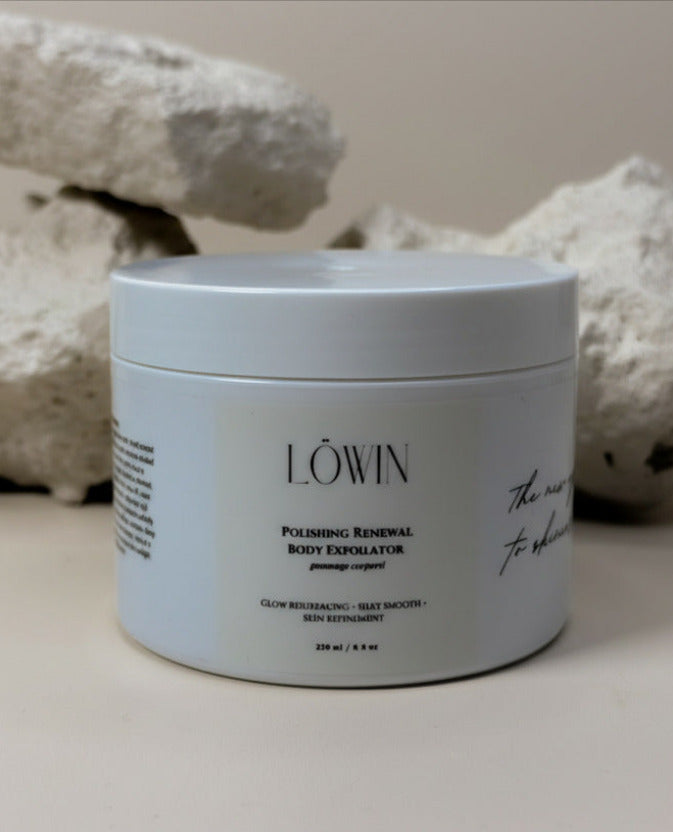 Jar of Löwin Polishing Renewal Body Exfoliator with decorative stones in the background