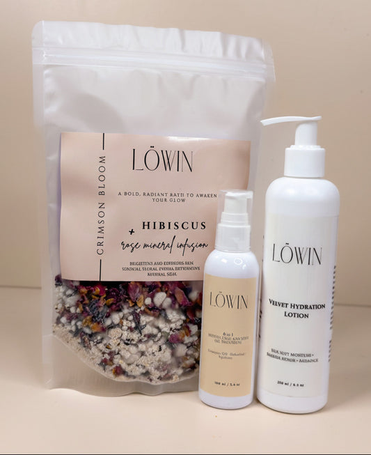 Löwin skincare products including a bath tea bag, a bottle of lotion, and a face and body oil on a beige background.