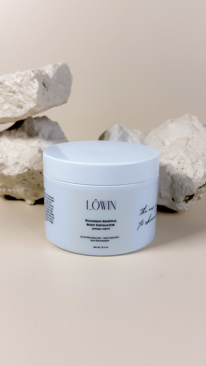 Löwin Body Polish on a neutral background with decorative stones.